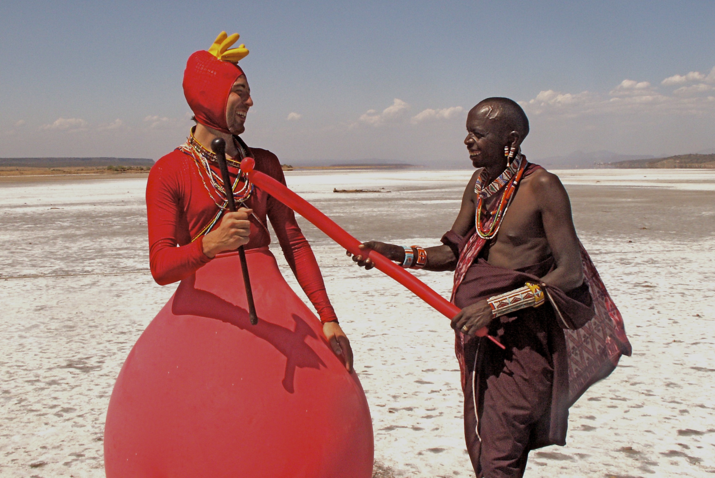 This image shows a Maasai warrior and a clown inside a balloon in order to convey an absurd picture of how ridiculous the world can be.